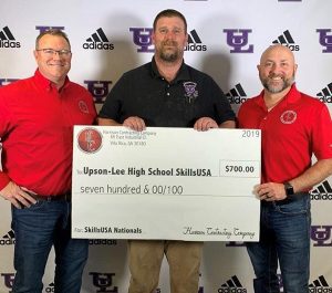 Harrison Contracting give a check to Upson-Lee High school